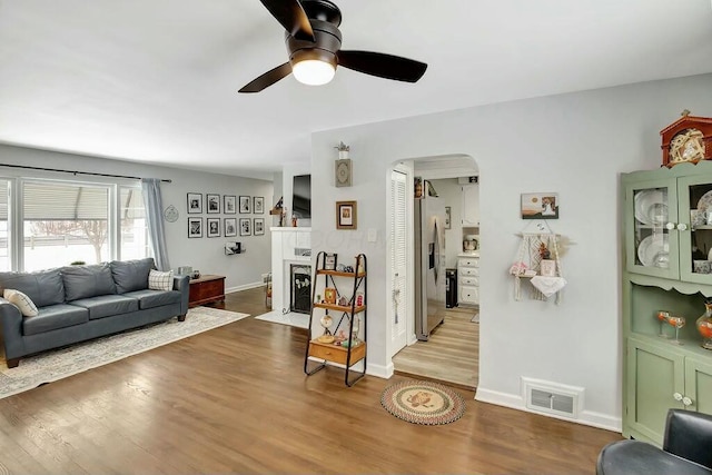 living room with ceiling fan and hardwood / wood-style floors