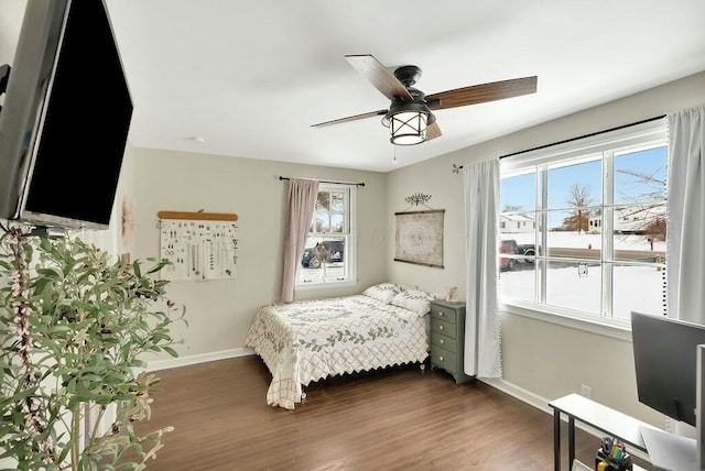 bedroom with ceiling fan and dark hardwood / wood-style flooring