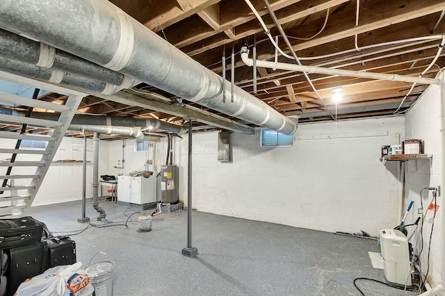 basement with independent washer and dryer and electric water heater