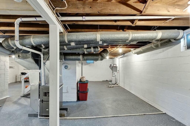 basement featuring water heater and heating unit