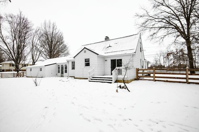 view of snow covered rear of property