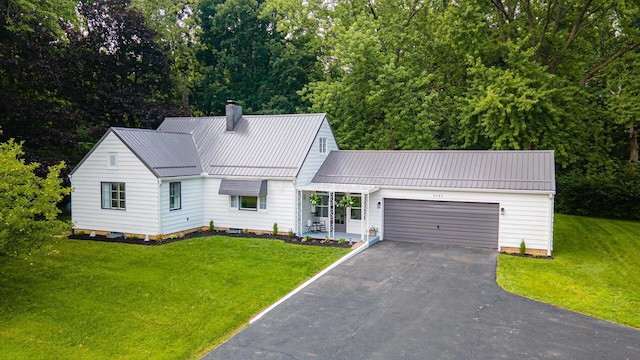 view of front of home featuring a garage and a front yard