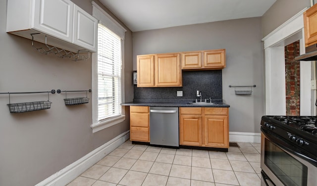 kitchen with light tile patterned flooring, sink, stainless steel dishwasher, decorative backsplash, and gas stove