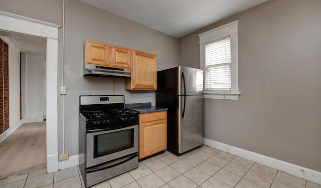 kitchen featuring light brown cabinets, light tile patterned floors, and appliances with stainless steel finishes