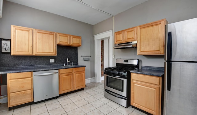 kitchen featuring light tile patterned floors, light brown cabinets, stainless steel appliances, and sink