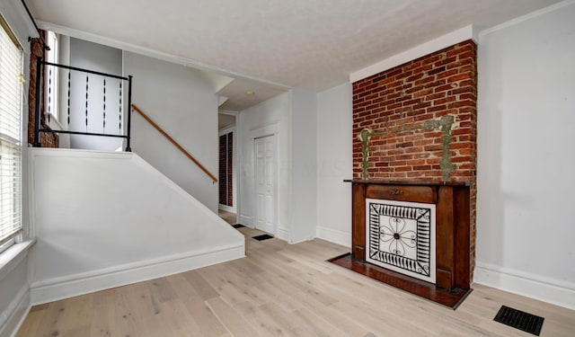 unfurnished living room featuring light wood-type flooring