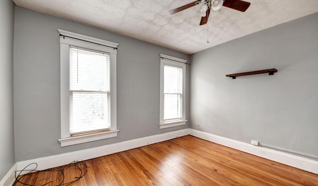 empty room featuring hardwood / wood-style floors, a textured ceiling, and ceiling fan