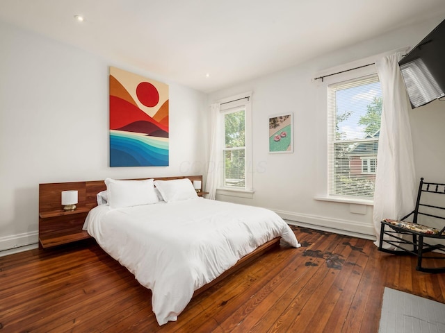 bedroom with dark hardwood / wood-style flooring