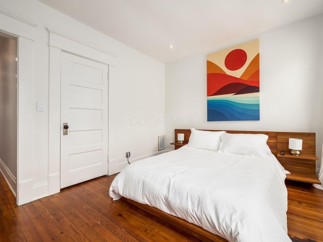 bedroom featuring hardwood / wood-style floors and a closet