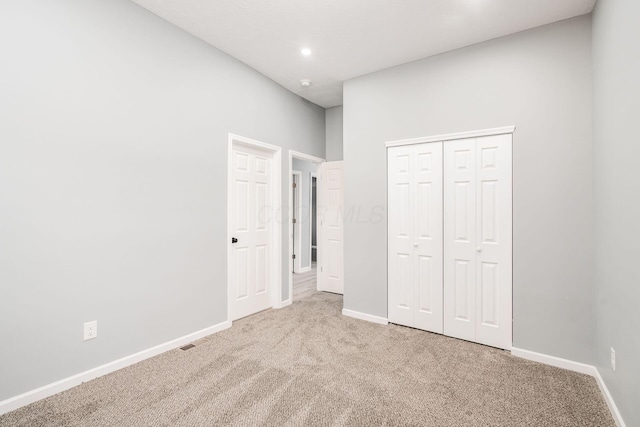 unfurnished bedroom featuring a closet and carpet