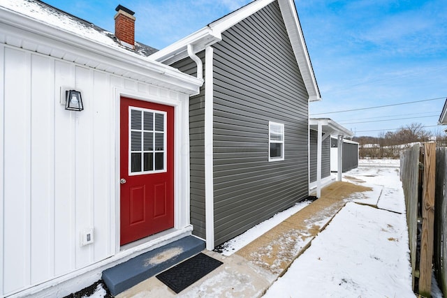 view of snow covered property entrance