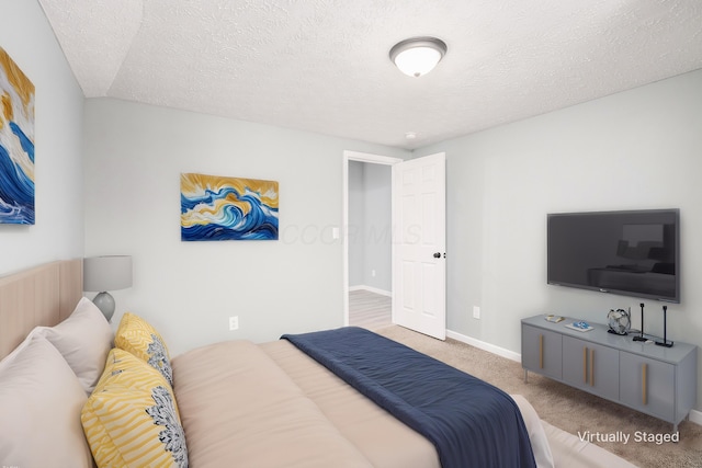 bedroom with carpet and a textured ceiling