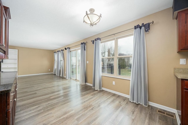 unfurnished living room with light hardwood / wood-style floors