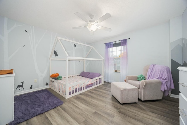 bedroom with ceiling fan and hardwood / wood-style floors