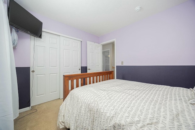 bedroom featuring light carpet and a closet