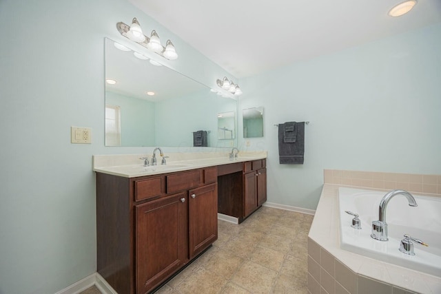 bathroom featuring tiled tub and vanity