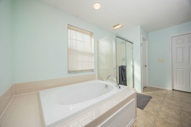 bathroom with separate shower and tub and tile patterned floors