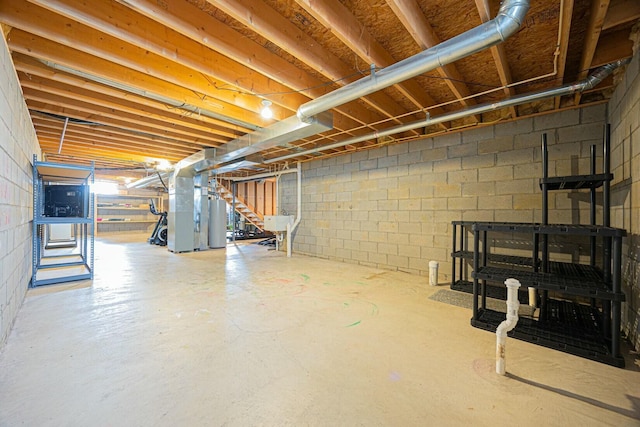 basement with heating unit, sink, and gas water heater