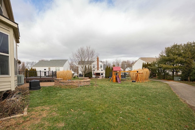 view of yard featuring central AC unit and a playground