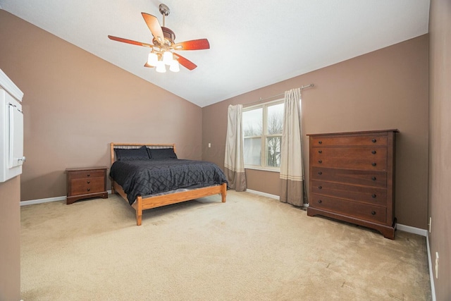 bedroom with light colored carpet, vaulted ceiling, and ceiling fan