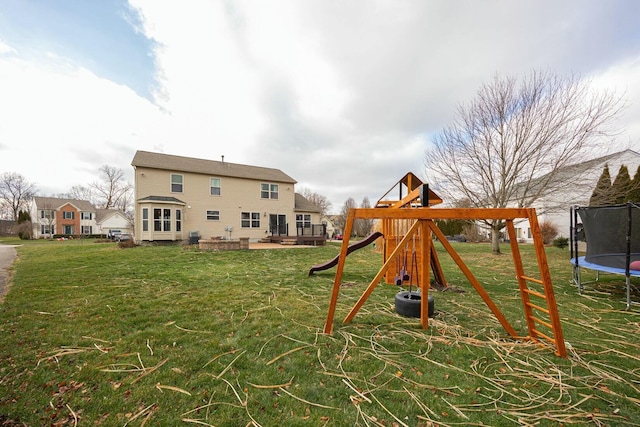 view of jungle gym with a lawn, a patio, and a trampoline