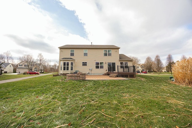 rear view of house with a yard, a patio, and a deck