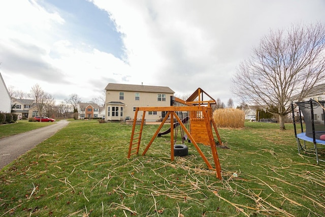 view of play area featuring a trampoline and a yard