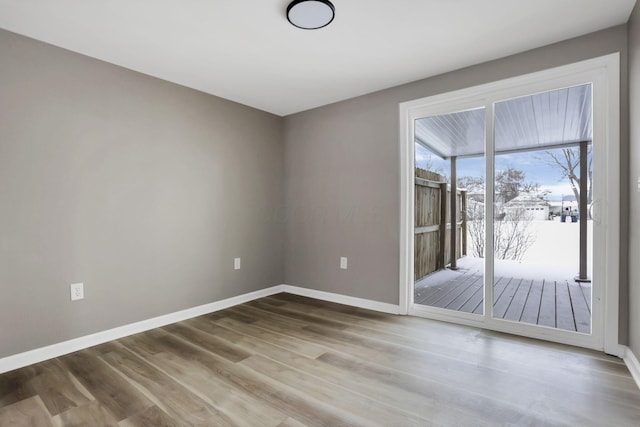 unfurnished room with hardwood / wood-style floors