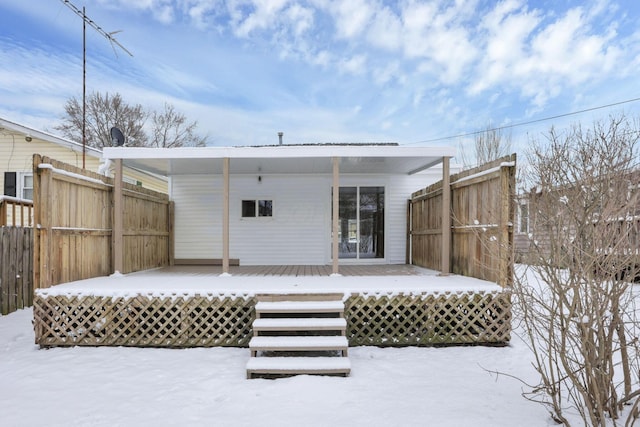 snow covered property featuring a wooden deck