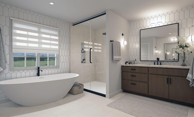 full bathroom with tile patterned floors, a tile shower, decorative backsplash, a freestanding tub, and vanity