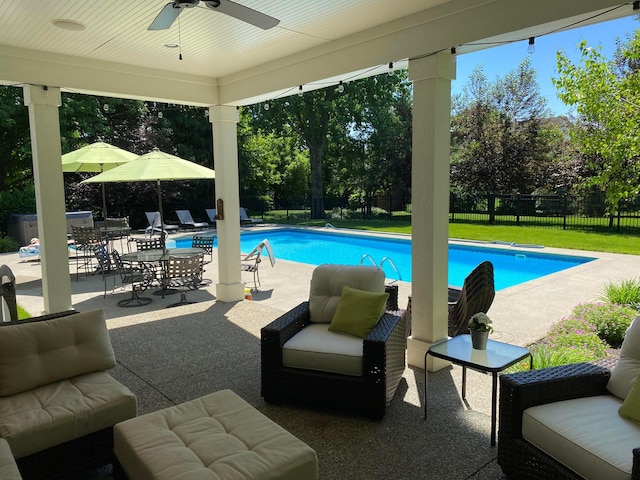 view of pool featuring a patio, outdoor lounge area, a fenced backyard, and a fenced in pool