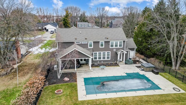 back of house with a patio, a lawn, a fenced backyard, and a fenced in pool