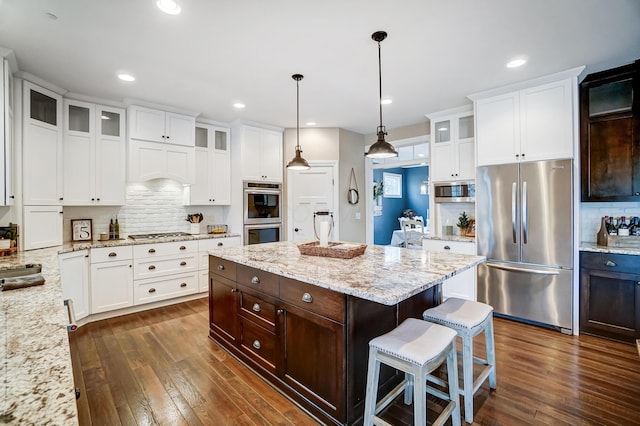 kitchen featuring stainless steel appliances, white cabinetry, dark brown cabinetry, and dark wood-type flooring