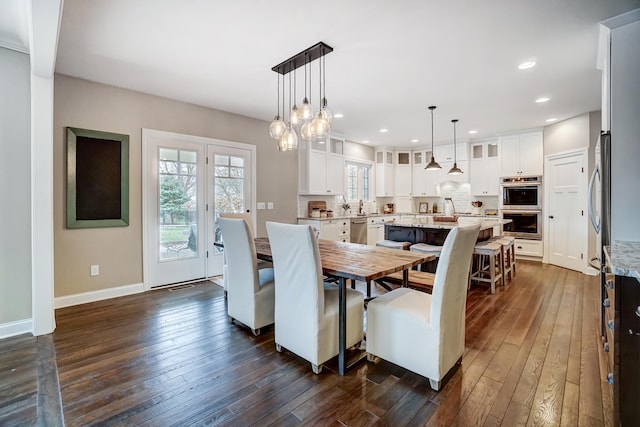 dining area featuring dark wood-type flooring, recessed lighting, and baseboards