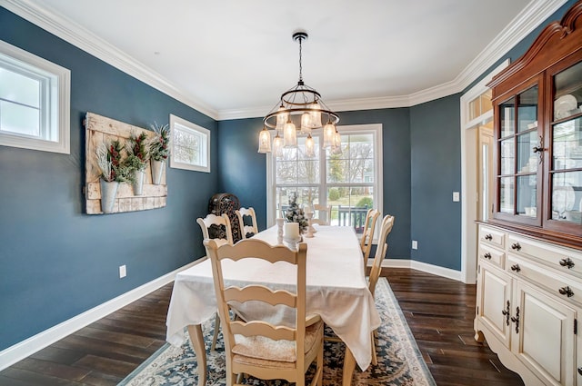 dining space with a chandelier, ornamental molding, dark wood finished floors, and baseboards