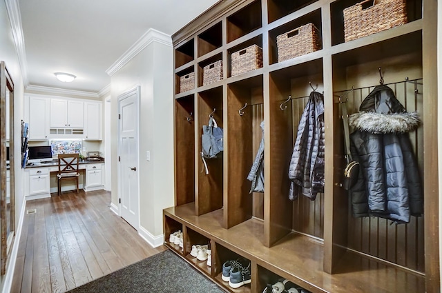 mudroom featuring wood-type flooring and crown molding