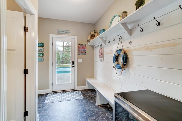 mudroom with stone finish floor and baseboards