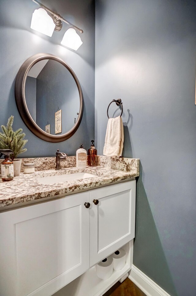 bathroom with vanity and baseboards