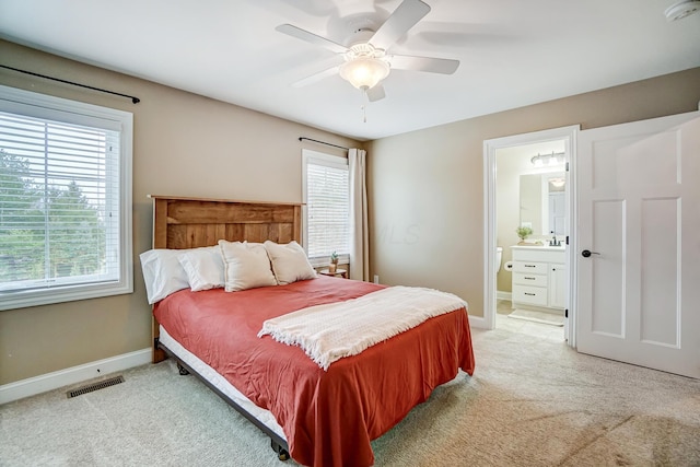 bedroom with light colored carpet, visible vents, and baseboards