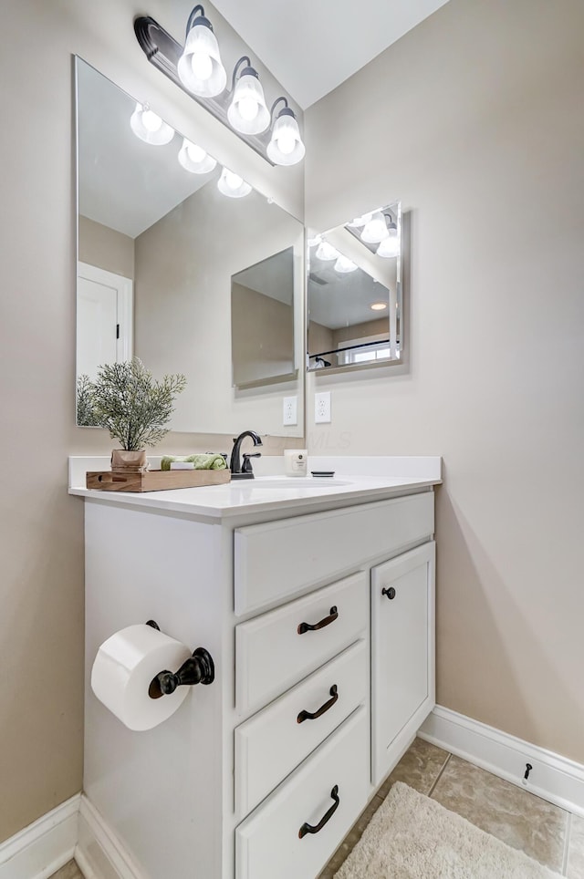 bathroom with vanity and baseboards