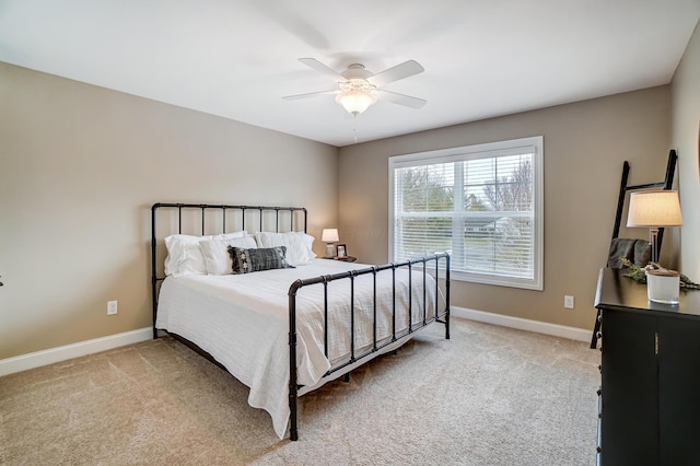 carpeted bedroom featuring a ceiling fan and baseboards