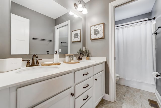 bathroom with visible vents, a sink, toilet, and tile patterned floors