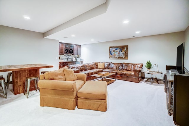 living room with recessed lighting, baseboards, and light colored carpet