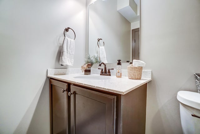 bathroom with toilet and vanity