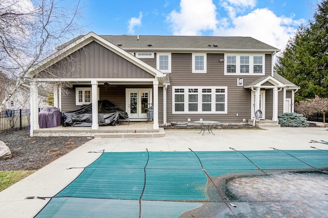 rear view of house with a fenced in pool, french doors, a patio, ceiling fan, and fence