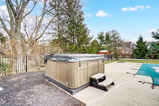 view of pool featuring a patio area, a hot tub, a fenced in pool, and a fenced backyard