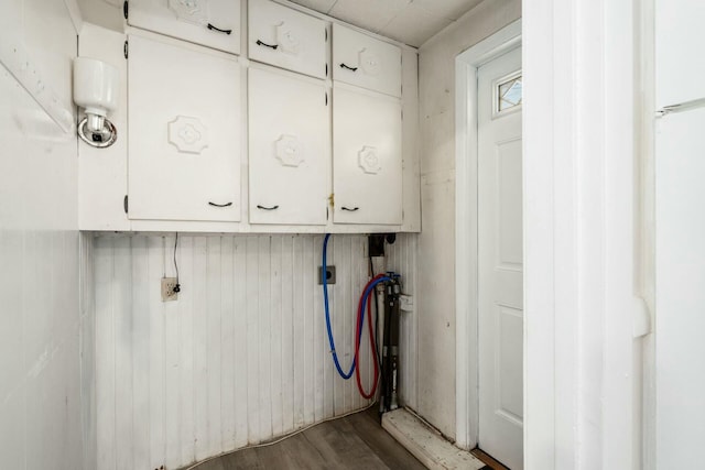 washroom featuring washer hookup, electric dryer hookup, cabinets, and hardwood / wood-style floors