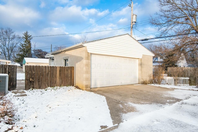 exterior space featuring an outbuilding, a garage, and central air condition unit