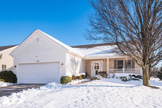 ranch-style house featuring covered porch and a garage