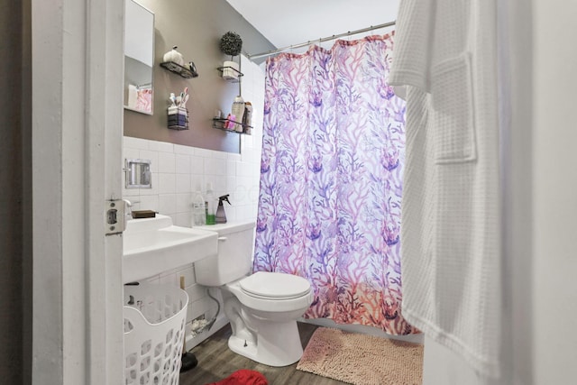 bathroom with toilet, tile walls, a shower with shower curtain, and wood-type flooring